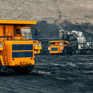 A large quarry dump truck in a coal mine. Loading coal into body work truck. Mining equipment for the transportation of minerals.