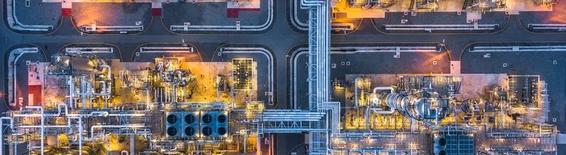 Aerial View Of Illuminated Factory In City At Night,