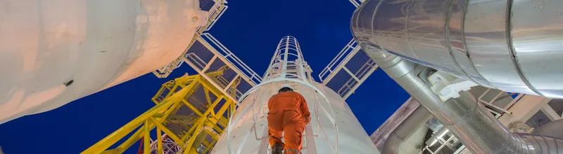 Engineering climb up to oil and gas process plant to observer gas dehydration processing in night shift