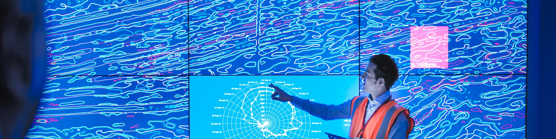 Geologists studying graphical display of oil and gas bearing rock on screens