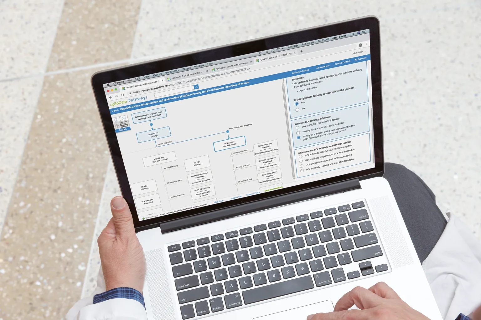 Physician using UpToDate on laptop